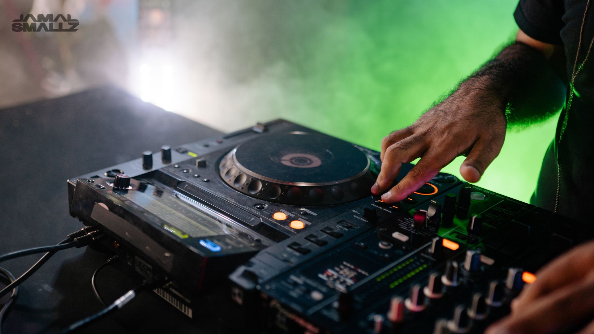 Chicago event DJ mixing live on turntables at a large stage wedding or corporate event